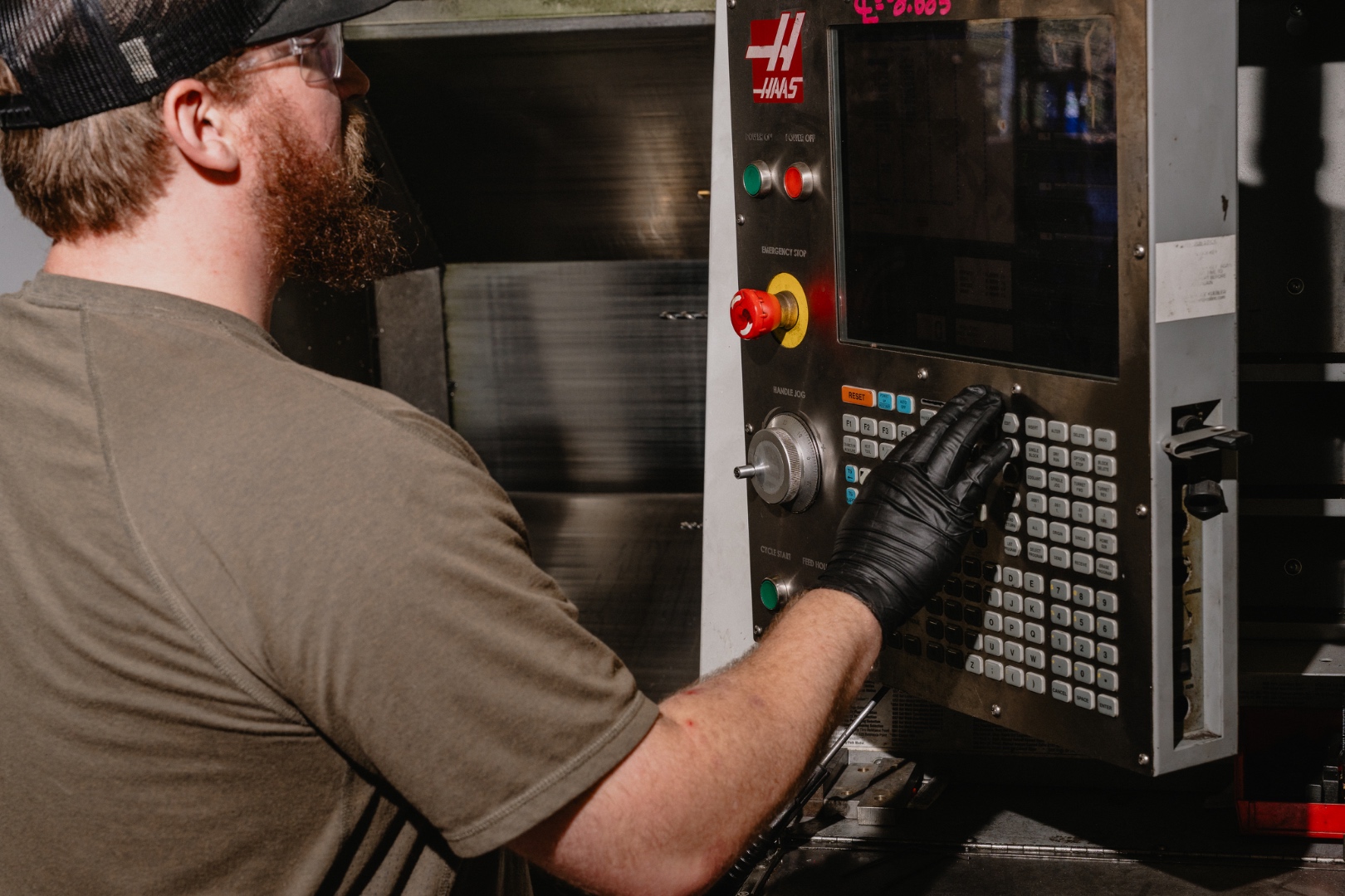 CNC machinist operating a Haas VMC at Cherry Creek Machine in Tulsa, Oklahoma