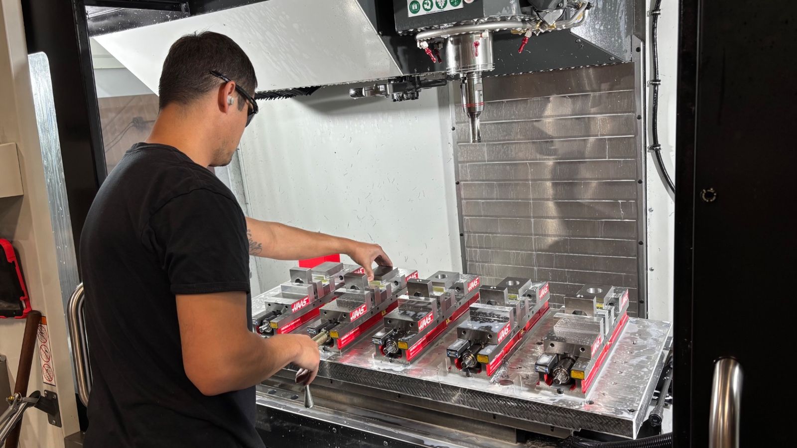 Machinist loading the next pallet on a Haas VF-4SS at Cherry Creek Machine's Tulsa shop, serving Oklahoma City manufacturers